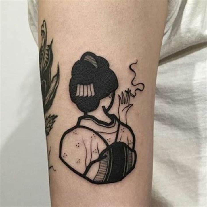 a person with a tattoo on their arm that has an image of the sun and