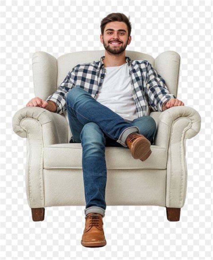 a young man sitting in the middle of ferns