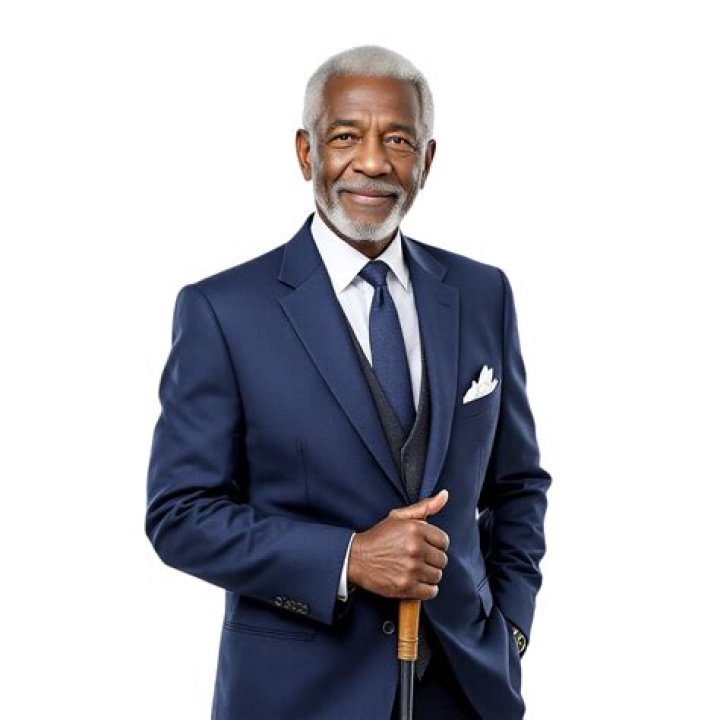 an older man in a black suit posing for a photo
