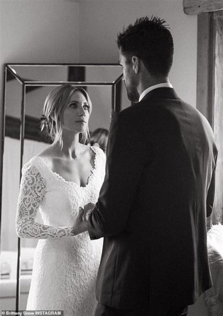Brittany Snow looks radiant in white while posing with fiancee Tyler