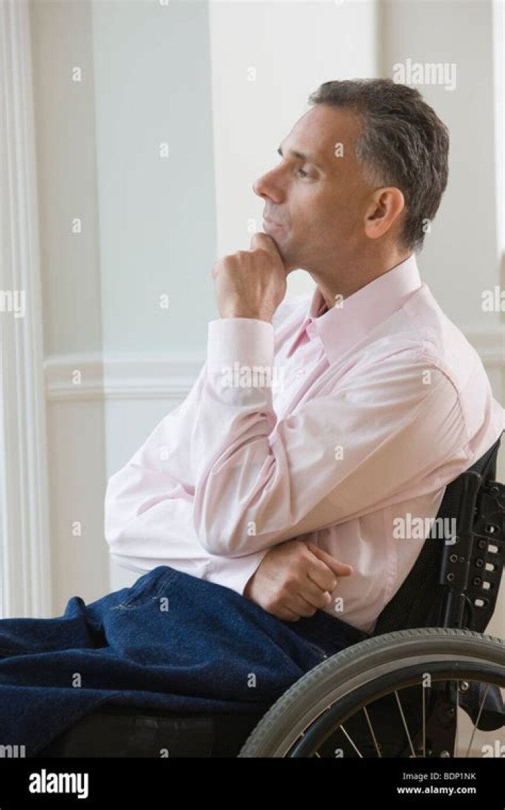 Businessman day dreaming on a wheelchair Stock Photo Alamy