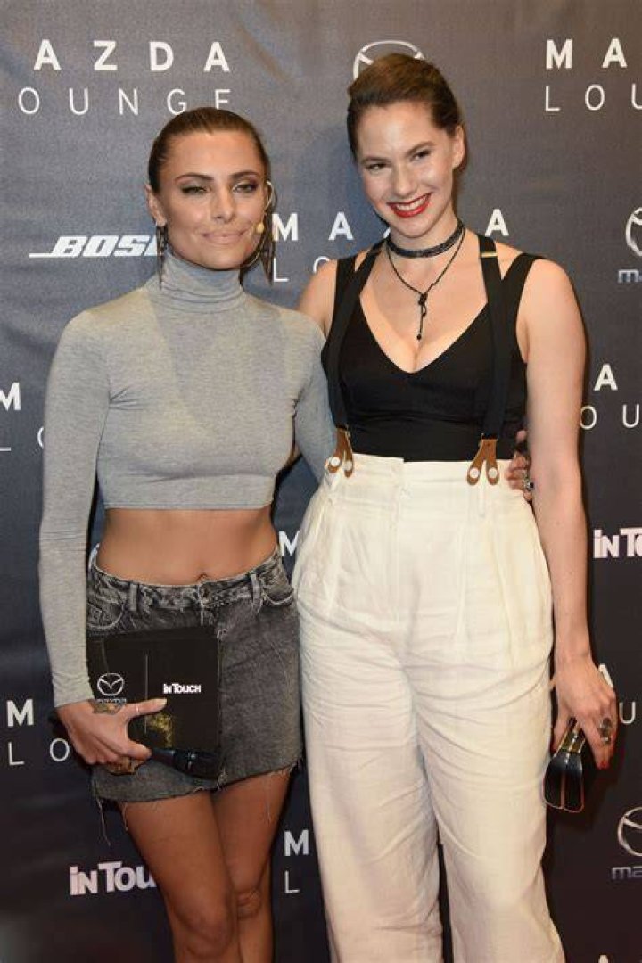 Emma Kathleen Ferrer wearing white pants with braces at the Mazda and