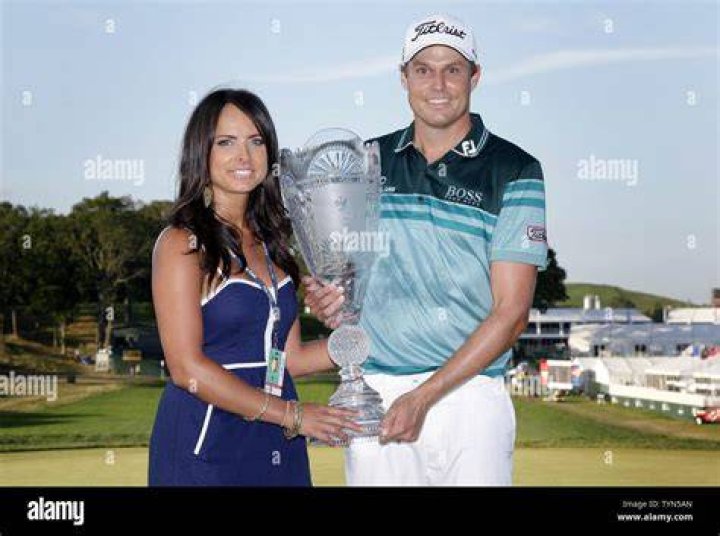 Nick Watney and wife Amber hold up the Championship Trophy after the
