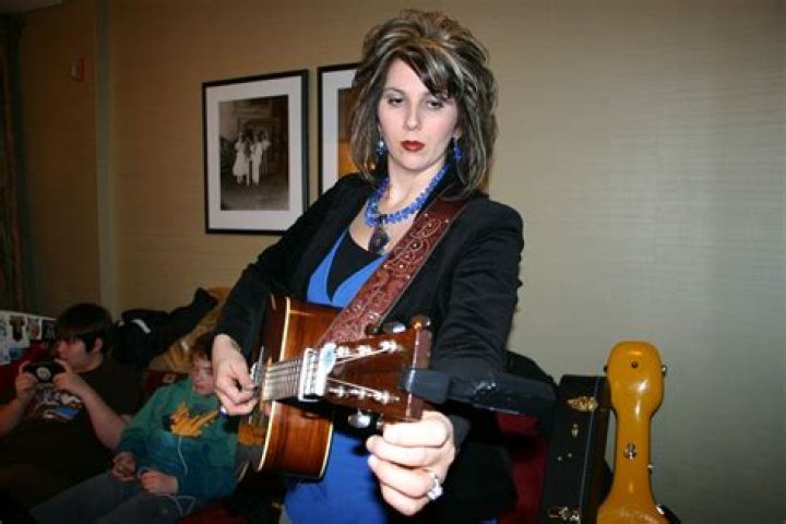Rebecca (Becky) Isaacs Bowman, of The Isaacs, tuning her guitar. Becky