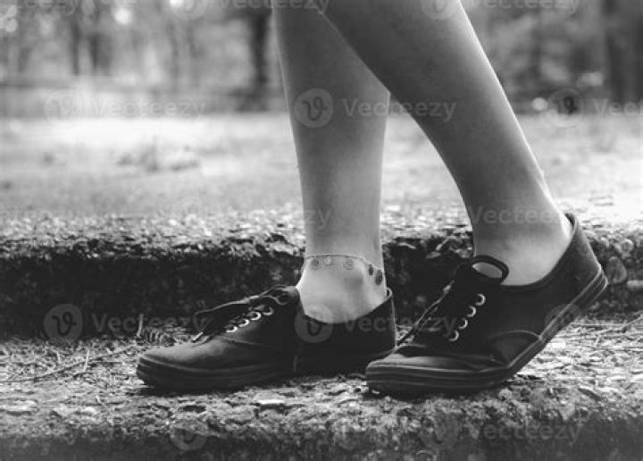 the legs of a person wearing socks with orange and brown designs on