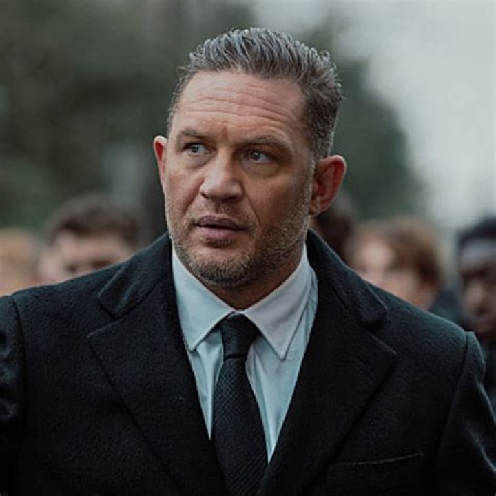 Tom Hardy in welltailored suit with Noomi Rapace at the Child 44